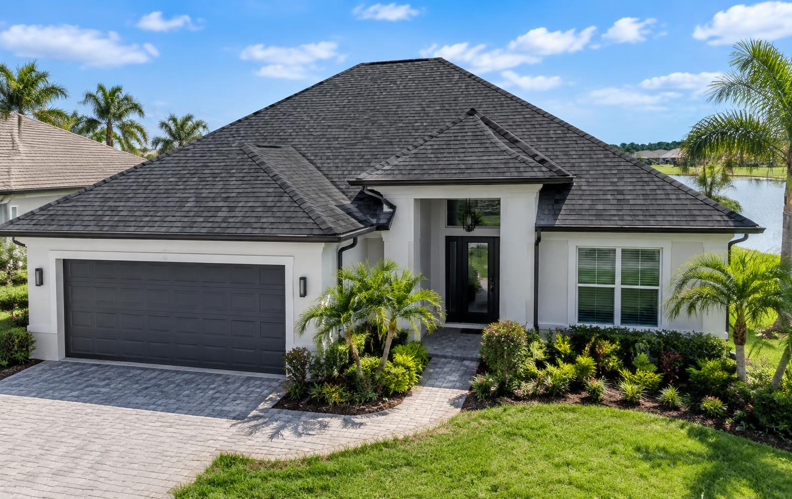 Modern Florida home with a freshly installed dark architectural shingle roof